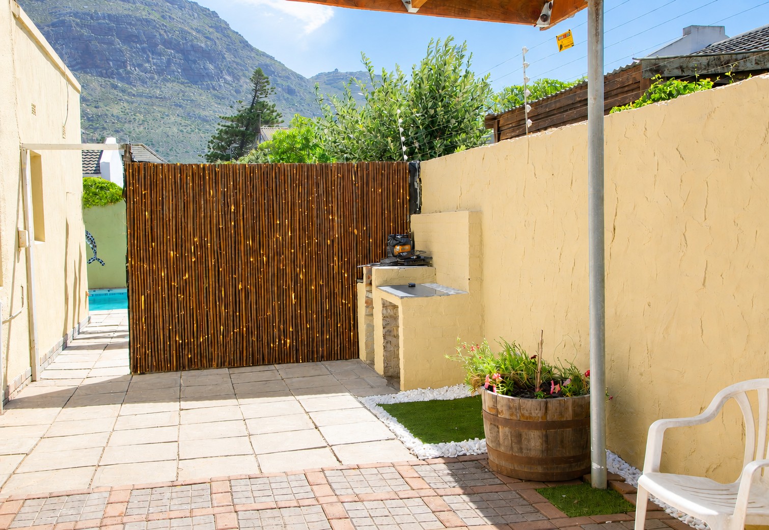 Covered patio with built-in braai and mountain views